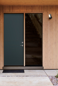 Eve Outdoor Cam installed near a door offers enhanced security with two-way communication via built-in microphone and speaker.