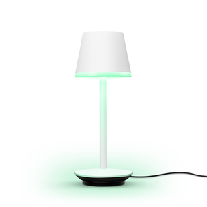 The Philips Hue Go Portable Table Lamp on its included charging base.
