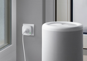 The Eve Energy plug, inserted into a standard power socket, controlling a room humidifier.