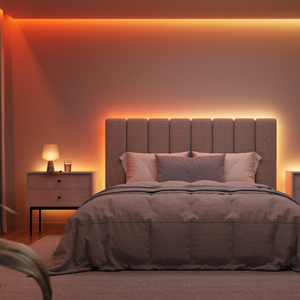 Nanoleaf Multicolor HD Lightstrip, illuminated, mounted behind headboard and matching end tables, in a darkened bedroom setting