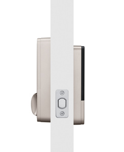 Both inner and outer panels of Aqara Smart Lock attached to a door, lock at left and keypad at right, deadbolt centered in door