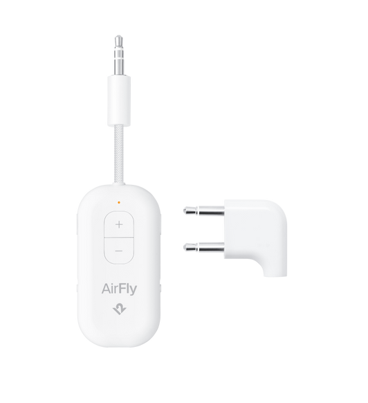 Twelve South AirFly Pro Deluxe with 3.5mm plug, volume control buttons, next to two-pin international airline adapter
