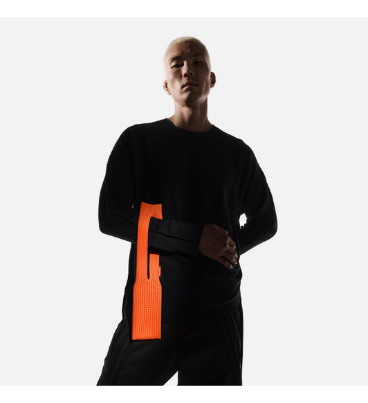 Model wearing iPhone Pocket on forearm, holding it through loop hole