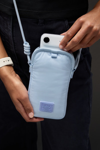 Herschel Cloudform Crossbody Bag for iPhone, blue colour, adjustable twill webbing strap attached, hand removing iPhone from interior