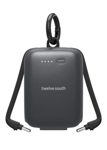 Twelve South Power Clip, front exterior, black colour, rounded corners, four LED power indicators on left, Twelve South logo at centre, integrated USB‑C cables extended at either side