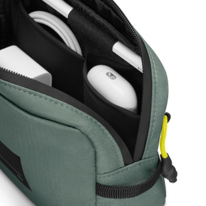 Native Union Active organizer, top exterior, green color, open, charger, cable, and AirPods case in pockets, Apple Pencil in holder, zipper pull with yellow lanyard at right