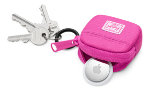 Herschel Cloudform AirTags Charm, top exterior, pink fabric color, open, with AirTag tucked half-way in, pink zipper pull at left, black metal keyring with attached keys