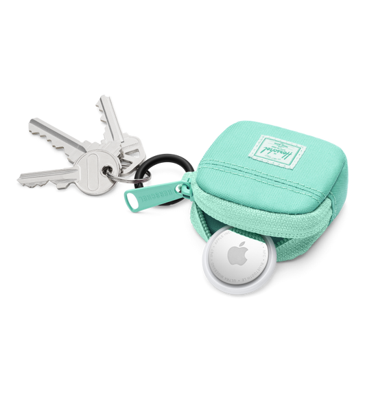 Herschel Cloudform AirTags Charm, top exterior, mint fabric color, open, with AirTag tucked half-way in, mint zipper pull at left, black metal keyring with attached keys