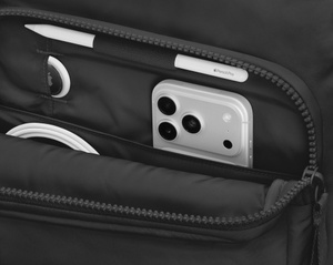 Herschel Cloudform Backpack XL, front exterior, black color, front zipper pouch open with iPhone, AirTag, and coiled cable inside