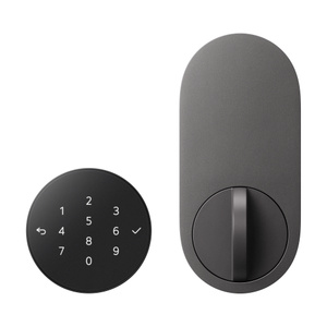 LG Smart Deadbolt Lock, front exterior, illuminated circular touch PIN pad with numbers, black color. Interior lock interface, oval shape, graphite color, thumbturn at bottom