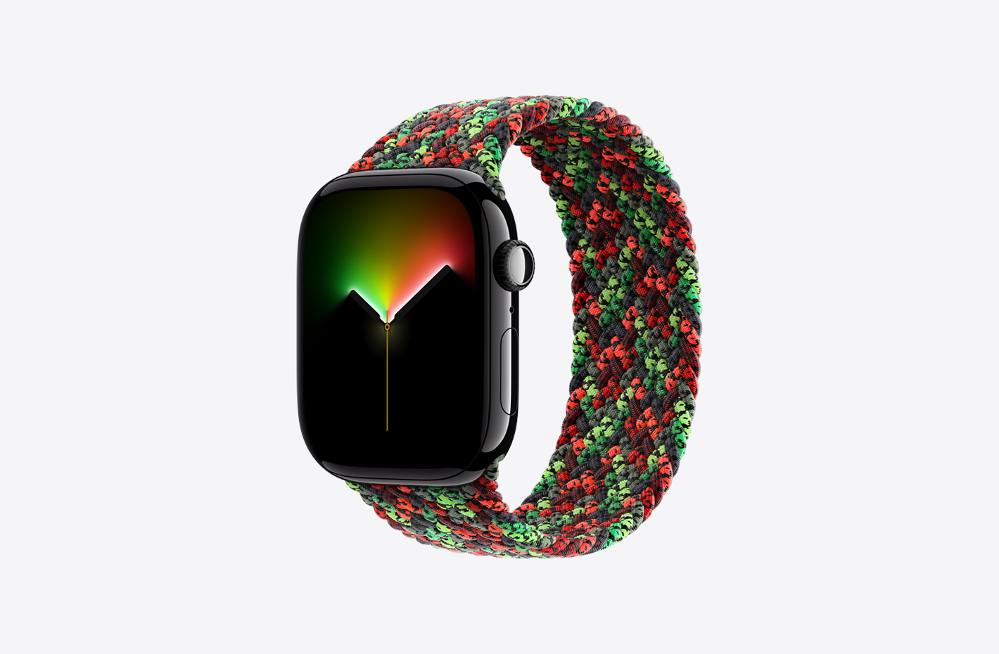 Apple Watch Series 11 搭配编织单圈表带，表带采用聚酯纱织物包裹的硅胶丝编织而成，具有无表扣设计和 Black Unity 系列 Unity Connection 配色 (黑色、红色、绿色的丝线织成编织图案)，表壳为亮黑色铝金属表壳，展示抛光外观、数码表冠及代表蜂窝网络表款的标记、麦克风、侧边按钮、模拟表盘、指针 (时针和分针以发光效果显示经过的时间)。