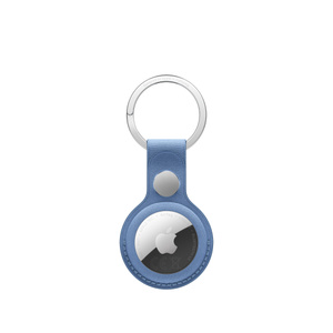 AirTag FineWoven Key Ring, snap closure button, stainless steel key ring, wildflower blue colour (greyish-blue) material covers the outer edge of AirTag, circular cutout, AirTag visible, Apple logo centred