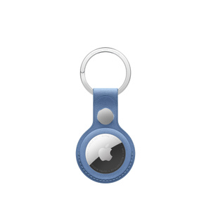 AirTag FineWoven Key Ring, snap closure button, stainless steel key ring, wildflower blue color (grayish-blue) material covers the outer edge of AirTag, circular cutout, AirTag visible, Apple logo centered
