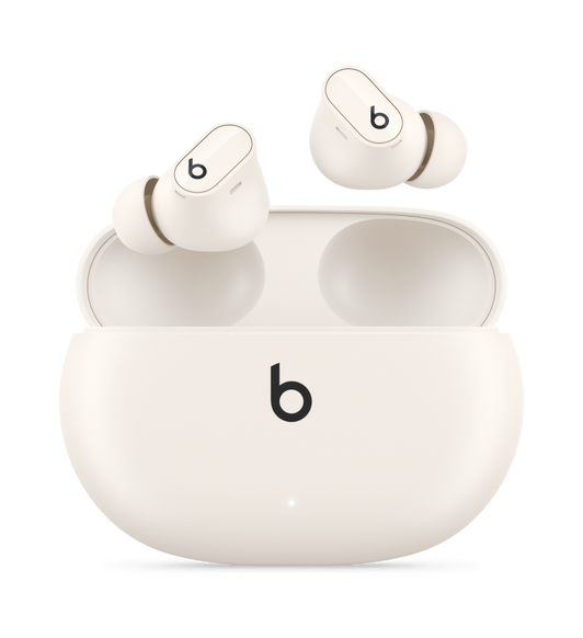 Beats Studio Buds + trådlösa öronsnäckor i krämvitt som svävar ovanför ett matchande laddningsfodral.