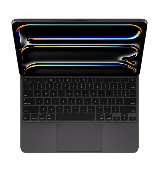 Imagen del iPad Pro acoplado a un Magic Keyboard negro que muestra las teclas negras con letras blancas, las teclas de flecha dispuestas en forma de T invertida, la hilera de teclas de función y el trackpad integrado