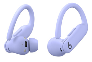 Angled view of Powerbeats Pro 2 wireless earbuds in Hyper Purple, showing flexible secure-fit earhooks, on-ear buttons and tactile volume rockers.