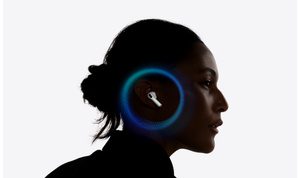 A person wearing AirPods Pro 3, hearing test active, hair tied back, a circular spectrum of frequency surrounds the ear