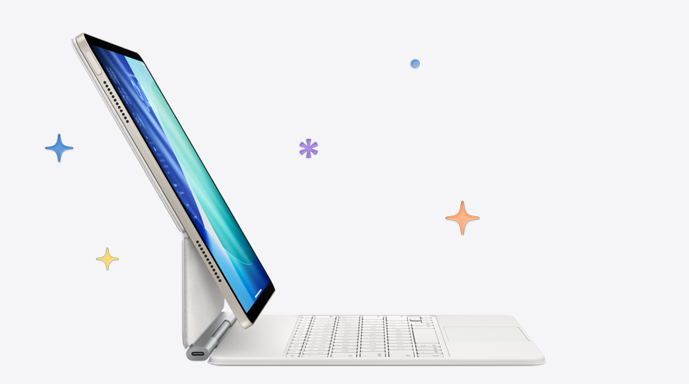 iPad Air i färgen stjärnglans, ansluten till ett vitt Magic Keyboard. I bakgrunden finns flerfärgade stjärnor och prickar