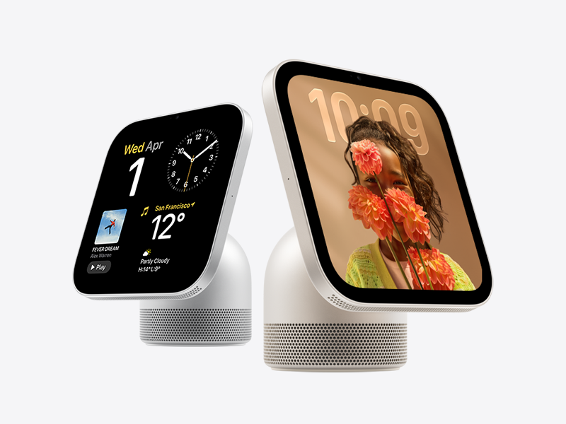 Apple HomeView devices: front exterior, rounded corners, flat sides, black display bezel. Microphone on left and right side of display. Circular speaker perforations at bottom of display and on colour-matching cylindrical speaker base.