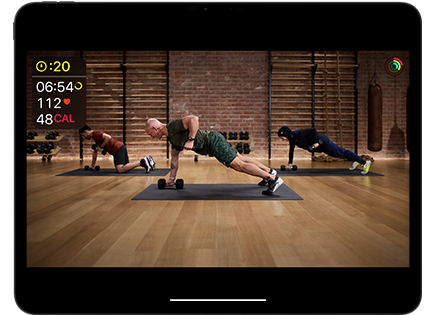 iPad Pro showing workout video, Activity rings and workout metrics, including time remaining, heart rate and calories burned
