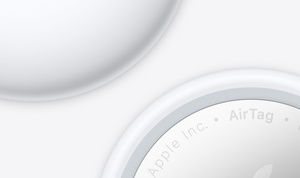 Close-up, partial back view of AirTag next to close-up, partial front view of AirTag.