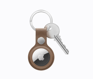 Top view of AirTag in a saddle brown leather key ring attached to a key.