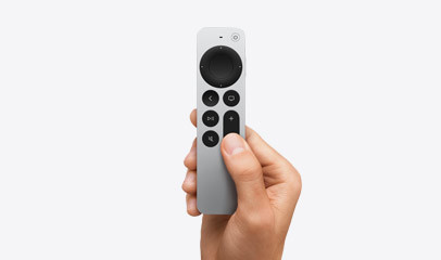 Siri Remote held in hand.