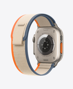 Back of Apple Watch Ultra Titanium Case with Orange and Beige Trail Loop band, soft nylon weave with pull tab closure