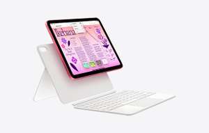 Angled view of iPad attaching to Magic Keyboard Folio, keyboard has a two-piece detachable design with back panel that has an adjustable stand.