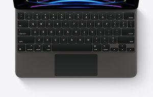 Top down view of iPad Pro attached to Magic Keyboard in black, showing the keys and built in trackpad.