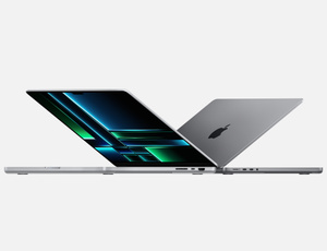 Angled side view of two open MacBook Pro models in Space Gray, sitting back-to-back. One is a 14-inch model, the other is a 16-inch&nbsp;model.