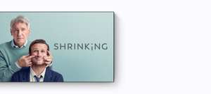Promo for new Apple Originals every month on Apple TV+, below is a TV screen showing the title Shrinking, Harrison Ford is standing behind a seated Jason Segel, Ford is gently pulling on Segel’s cheeks to create a smiling expression, both are wearing formal attire