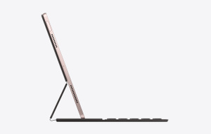 Side view of iPad Air attached to Smart Keyboard folio angled for viewing and typing.