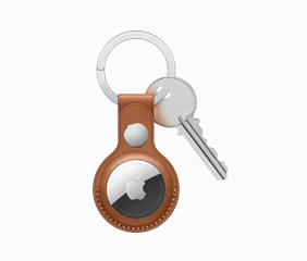 Gallery of AirTag in a saddle-brown leather key ring.